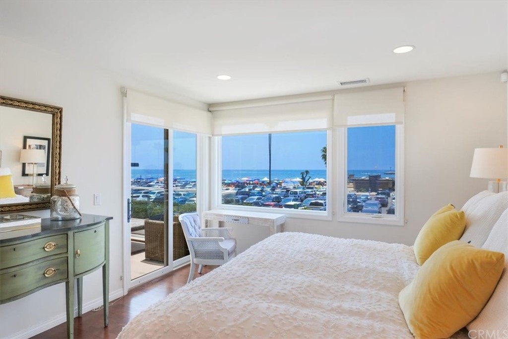 3036 Breakers Drive Corona del Mar, CA 92625 - Photo 13 of 48 a spacious bedroom with a large bed and a large window