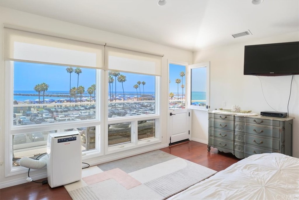 3036 Breakers Drive Corona del Mar, CA 92625 - Photo 16 of 48 a bedroom with a bed and a television