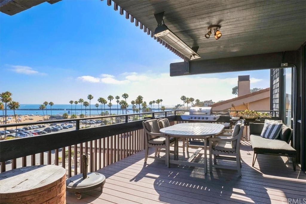 3036 Breakers Drive Corona del Mar, CA 92625 - Photo 38 of 48 a view of a roof deck with dining table and chairs with wooden floor