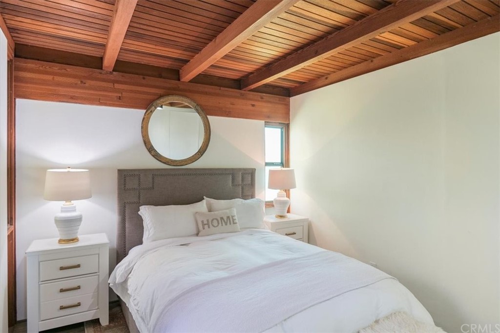 3036 Breakers Drive Corona del Mar, CA 92625 - Photo 40 of 48 a bedroom with a bed a vanity and a night stand