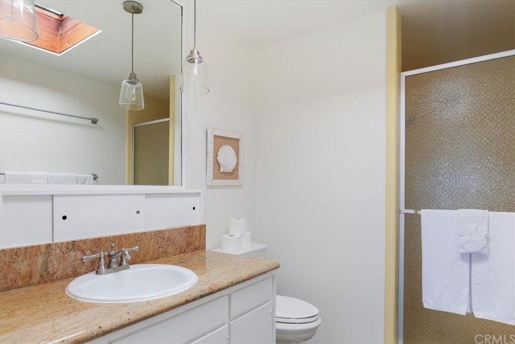 3036 Breakers Drive Corona del Mar, CA 92625 - Photo 41 of 48 a bathroom with a sink toilet a mirror and shower
