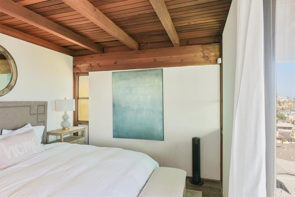 3036 Breakers Drive Corona del Mar, CA 92625 - Photo 43 of 48 a bedroom with a bed and a mirror