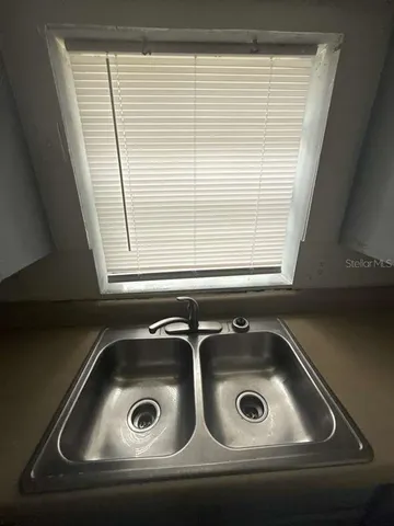 a bathroom with a granite countertop sink toilet a mirror and bathtub