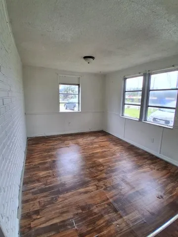 a kitchen with a sink a refrigerator and cabinets