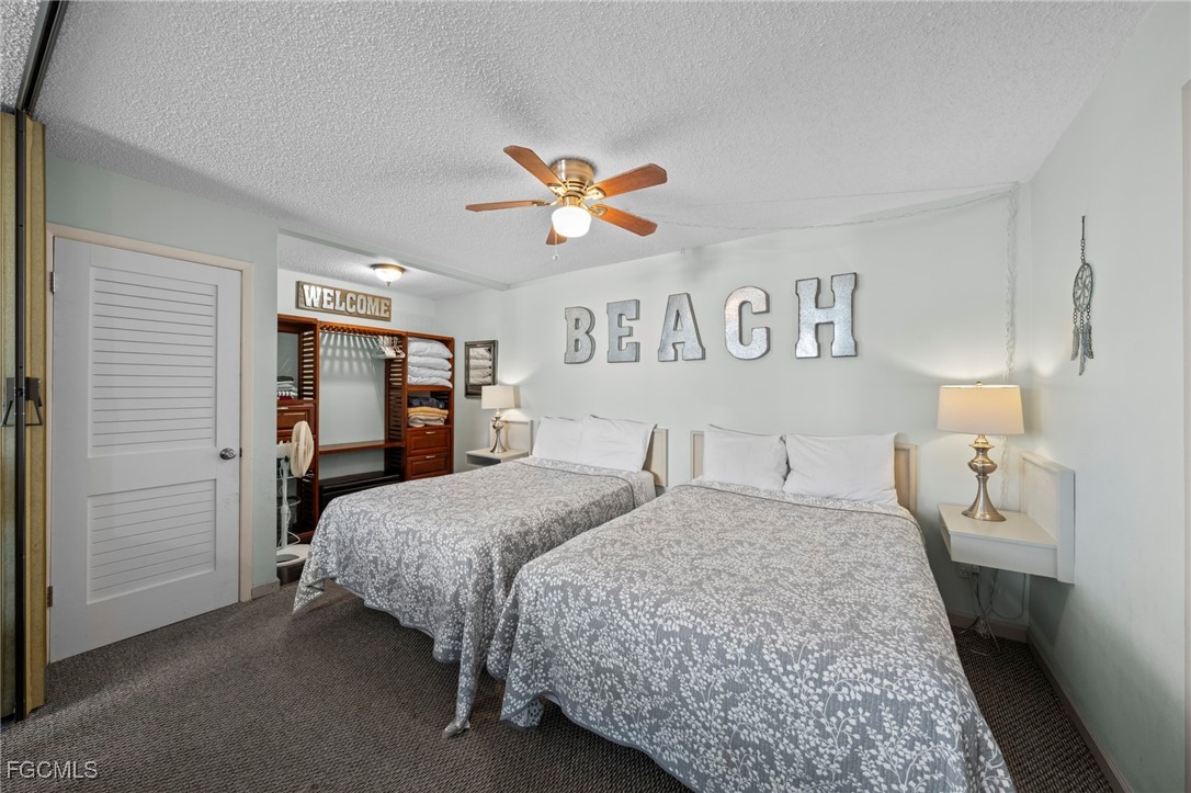 5600 Bonita Beach Road Southwest, Unit 204 Bonita Springs, FL 34134 - Photo 11 of 23 a bedroom with a bed and a walk in closet