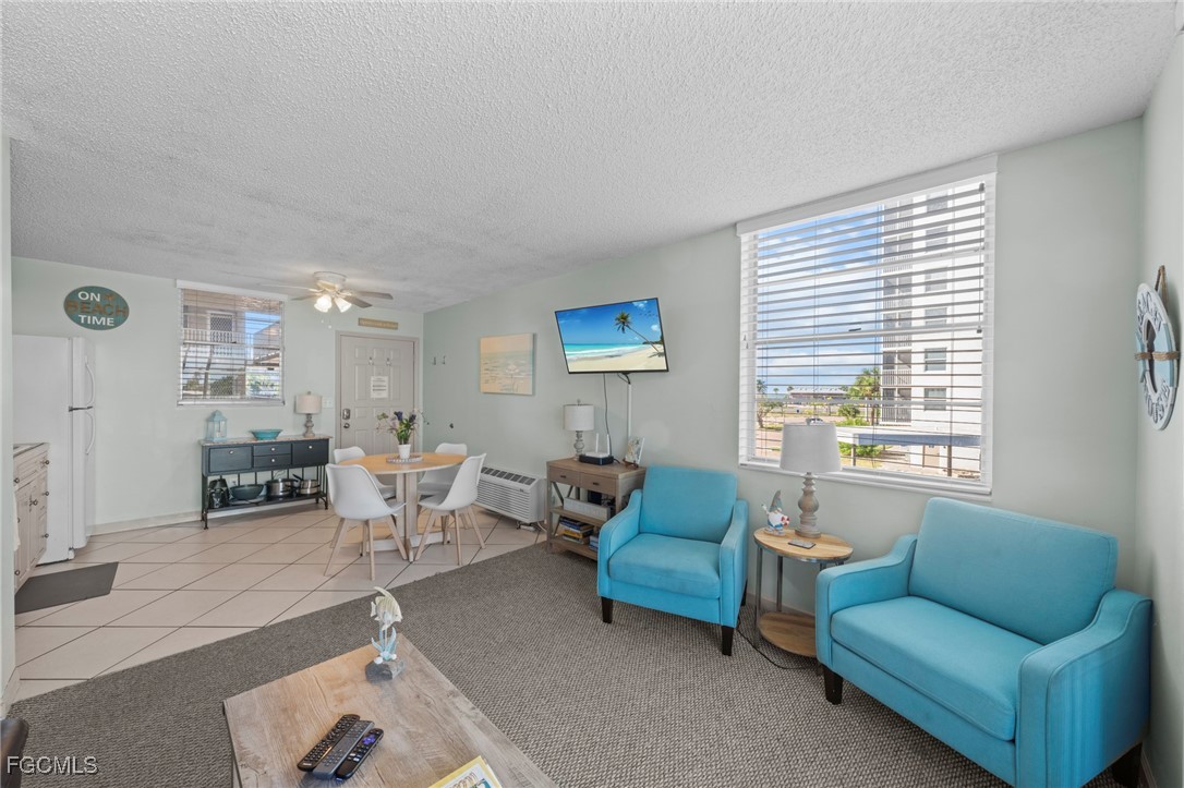 5600 Bonita Beach Road Southwest, Unit 204 Bonita Springs, FL 34134 - Photo 2 of 23 a living room with furniture and a large window