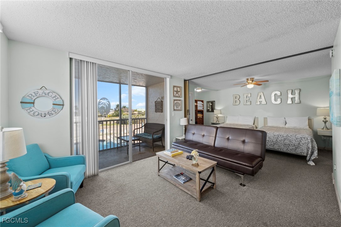 5600 Bonita Beach Road Southwest, Unit 204 Bonita Springs, FL 34134 - Photo 4 of 23 a living room with furniture and a large window