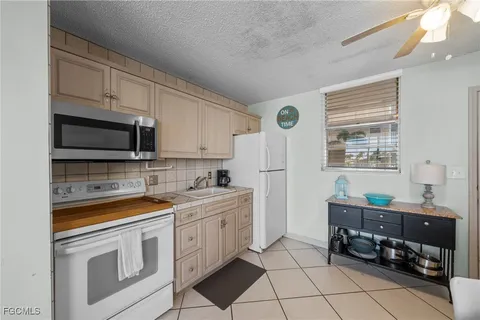 a kitchen with a sink stove and microwave