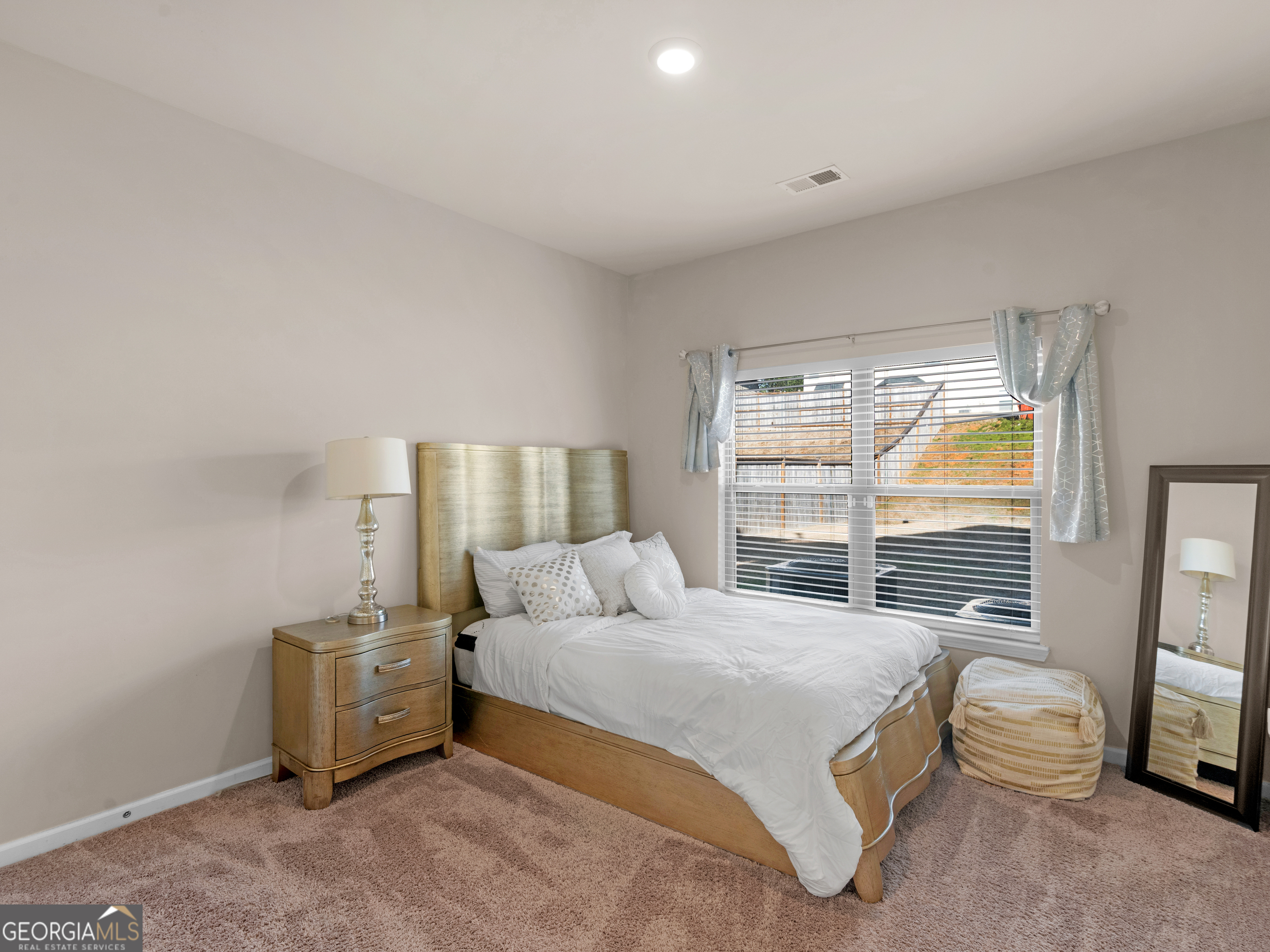 630 Oakville Trail Hampton, GA 30228 - Photo 20 of 36 a bedroom with a bed and a mirror