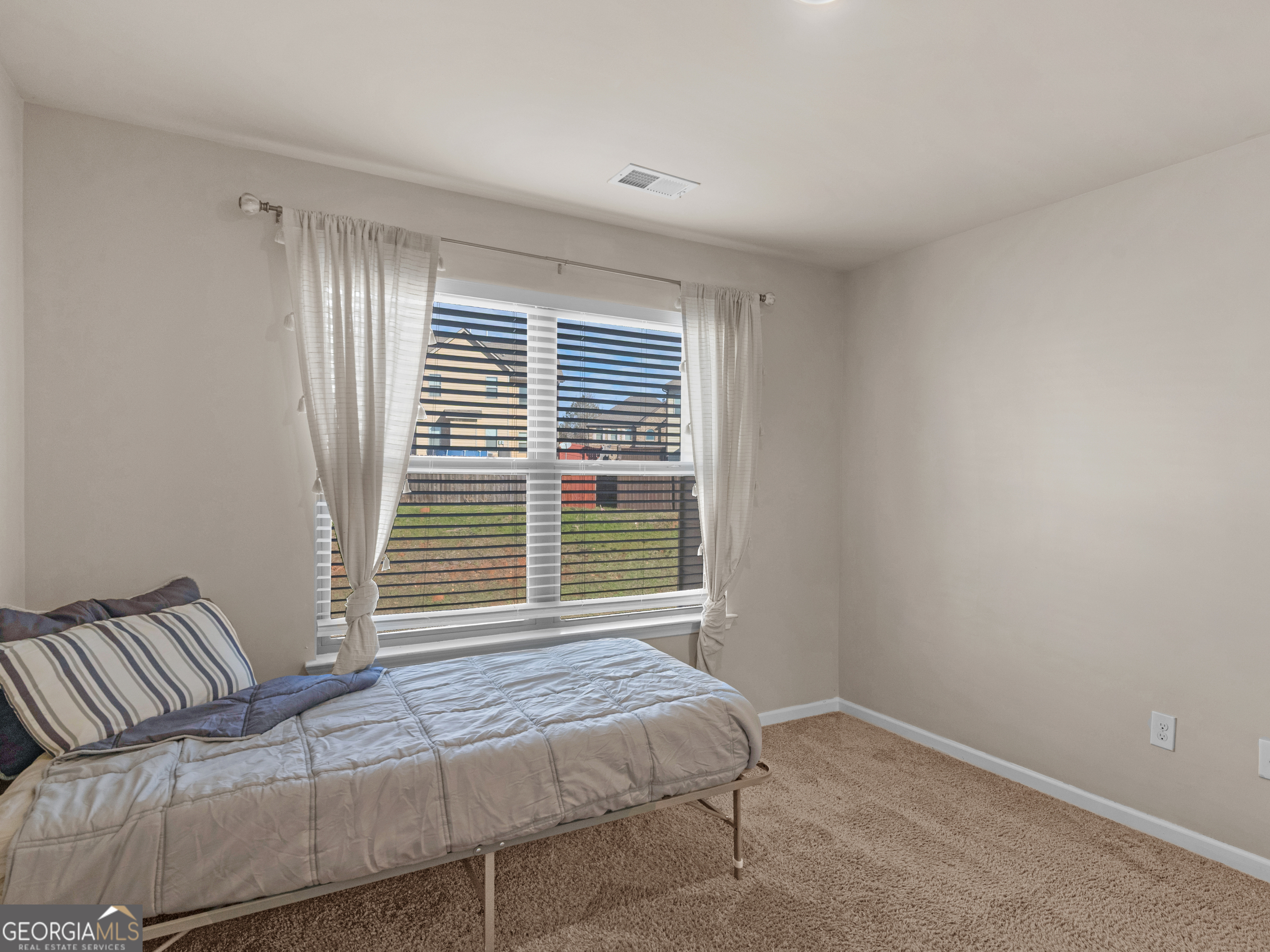 630 Oakville Trail Hampton, GA 30228 - Photo 33 of 36 a bedroom with a bed and a window