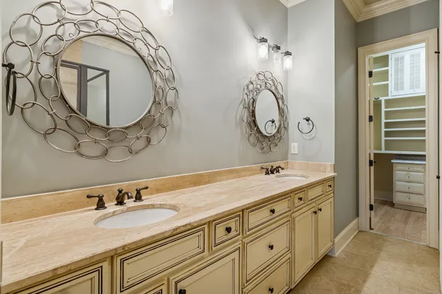 a bathroom with a granite countertop sink and mirror