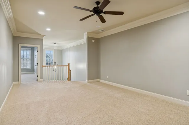 a view of a livingroom with a ceiling fan and window
