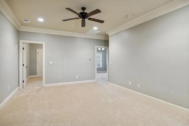 an empty room with fan and a ceiling fan