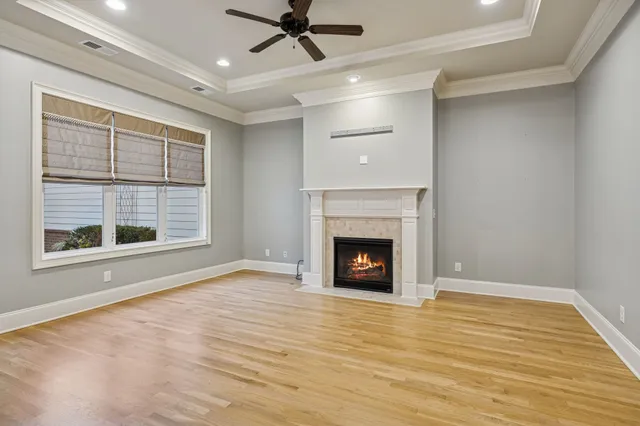 a view of an empty room with a fireplace and a window