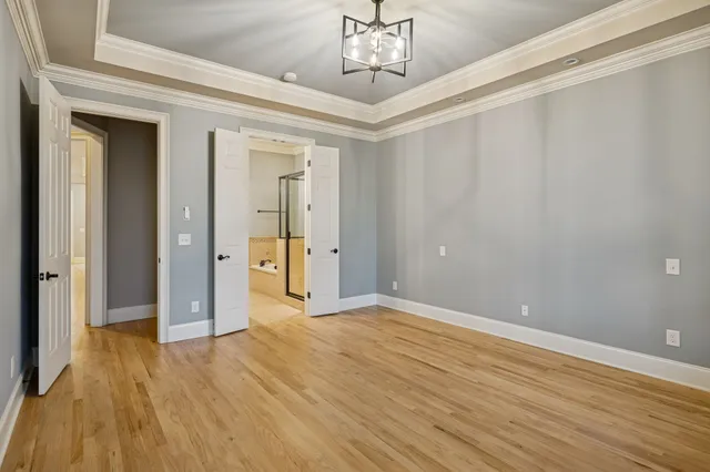 a view of empty room with wooden floor