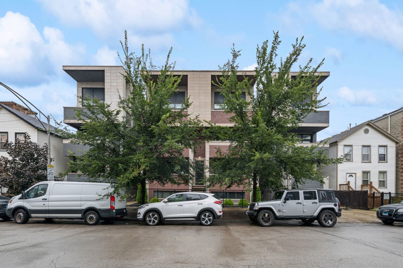 a view of cars parked in front of a building