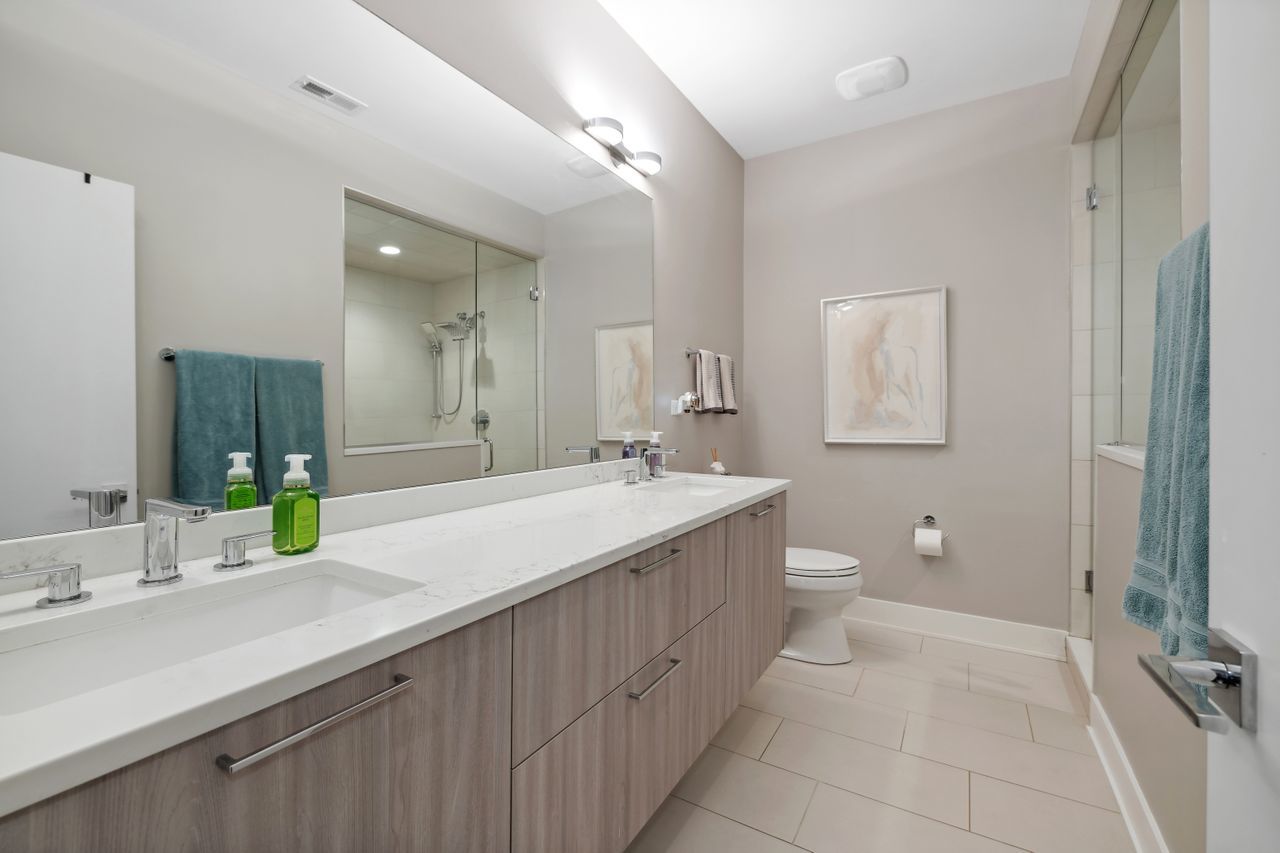 1224 West Ohio Street, Unit 2E Chicago, IL 60642 - Photo 11 of 17 a spacious bathroom with a double vanity sink mirror and toilet