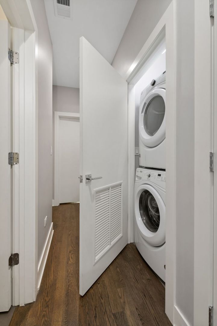 1224 West Ohio Street, Unit 2E Chicago, IL 60642 - Photo 15 of 17 a view of a hallway with washer and dryer