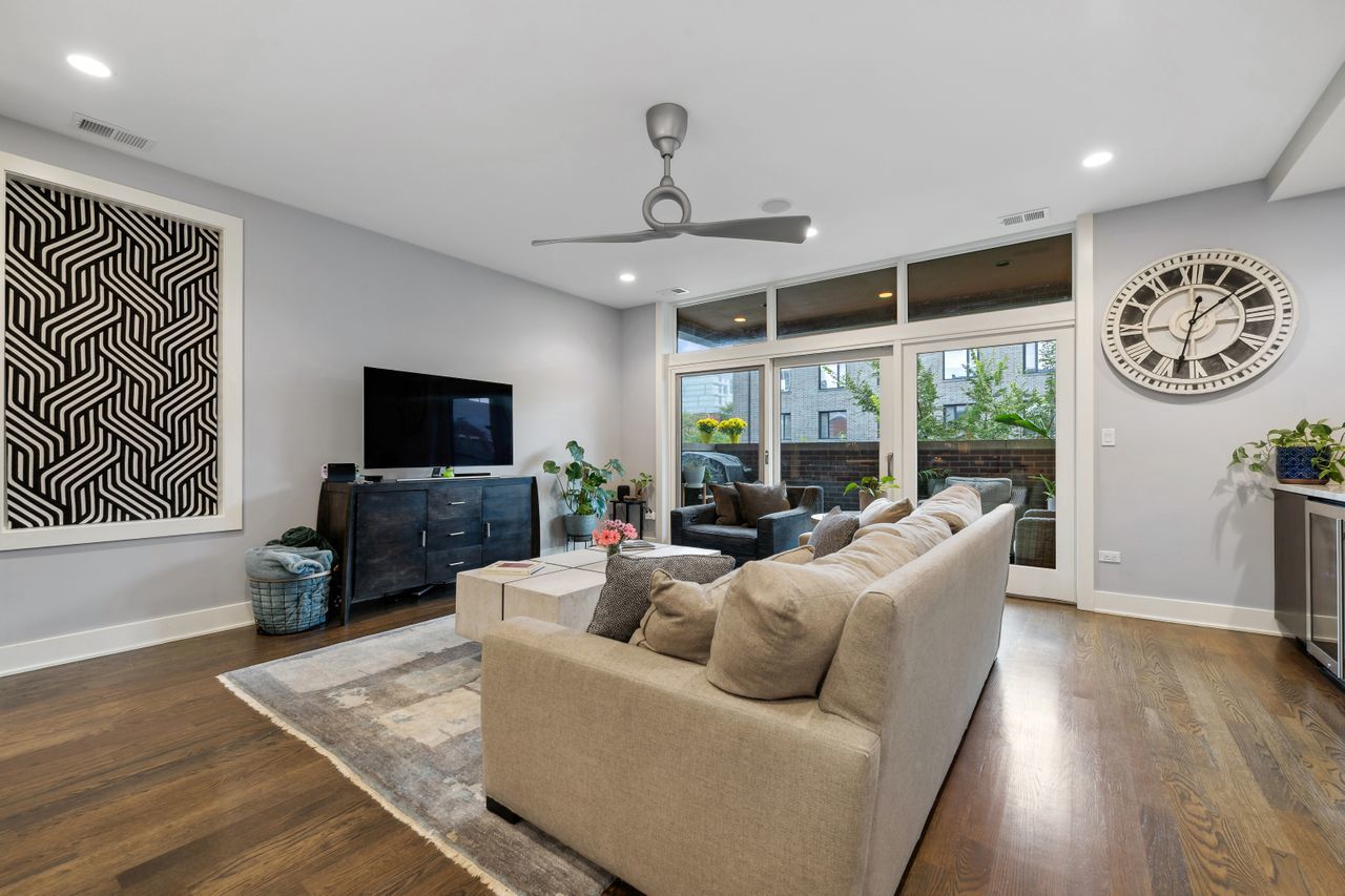 1224 West Ohio Street, Unit 2E Chicago, IL 60642 - Photo 3 of 17 a living room with furniture a fireplace and a flat screen tv