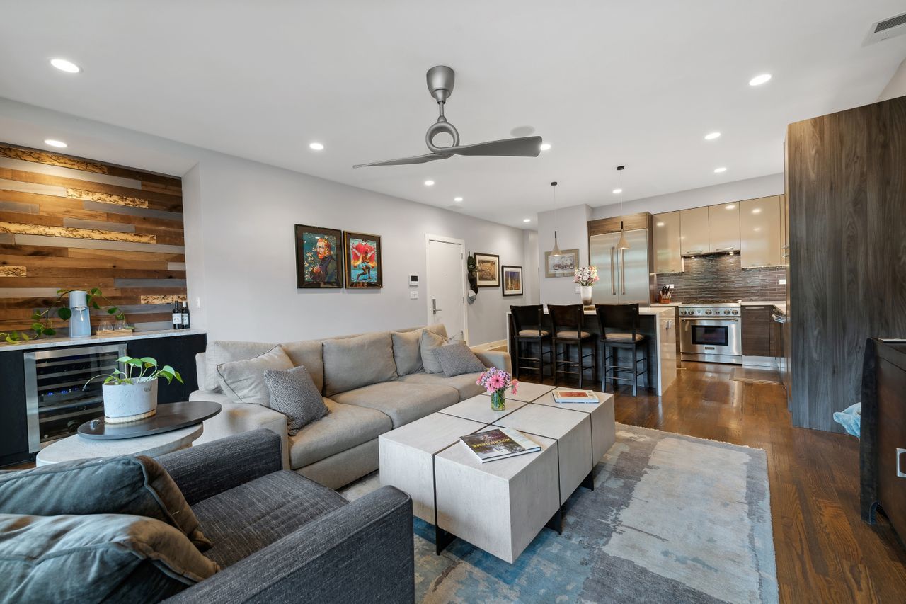 1224 West Ohio Street, Unit 2E Chicago, IL 60642 - Photo 5 of 17 a living room with furniture and kitchen view