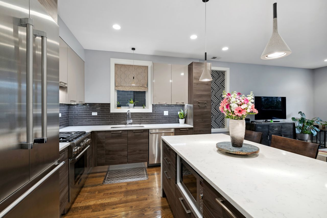 1224 West Ohio Street, Unit 2E Chicago, IL 60642 - Photo 7 of 17 a kitchen with stainless steel appliances a sink and cabinets