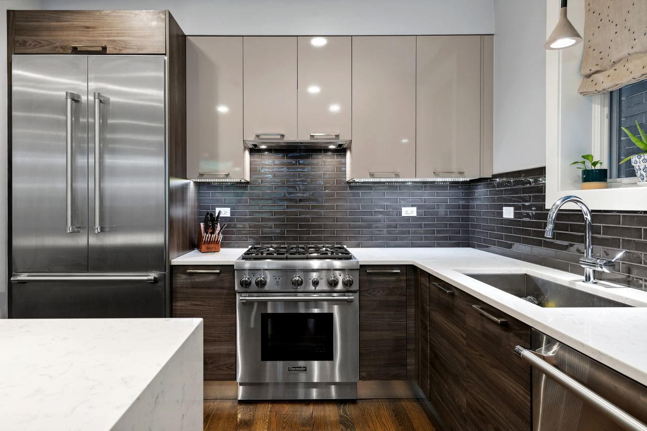 1224 West Ohio Street, Unit 2E Chicago, IL 60642 - Photo 8 of 17 a kitchen with a stove top oven and sink