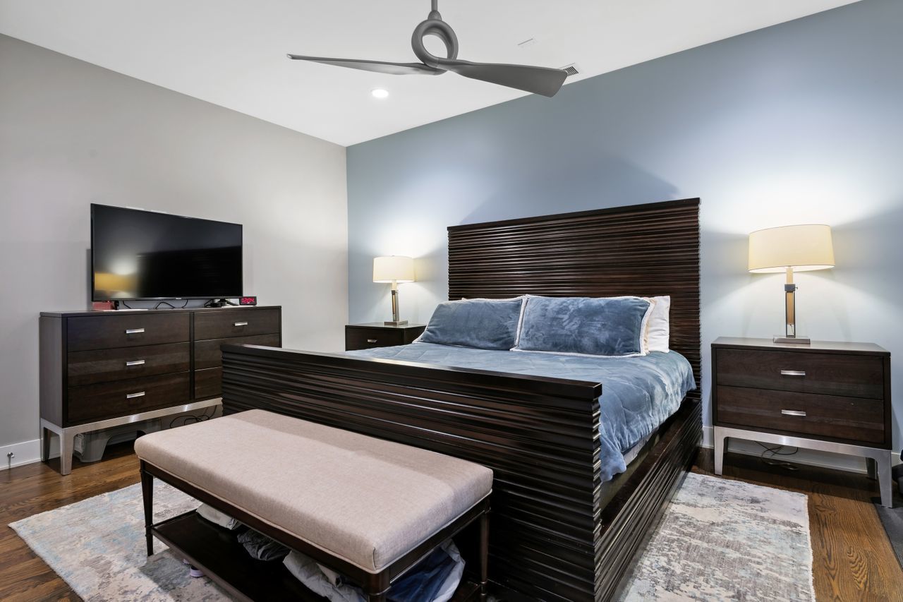 1224 West Ohio Street, Unit 2E Chicago, IL 60642 - Photo 9 of 17 a bedroom with a bed and a flat screen tv