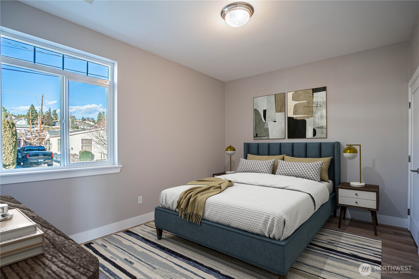 744 Wapato Way, Unit A Manson, WA 98831 - Photo 12 of 32 a bedroom with a bed lamp and window