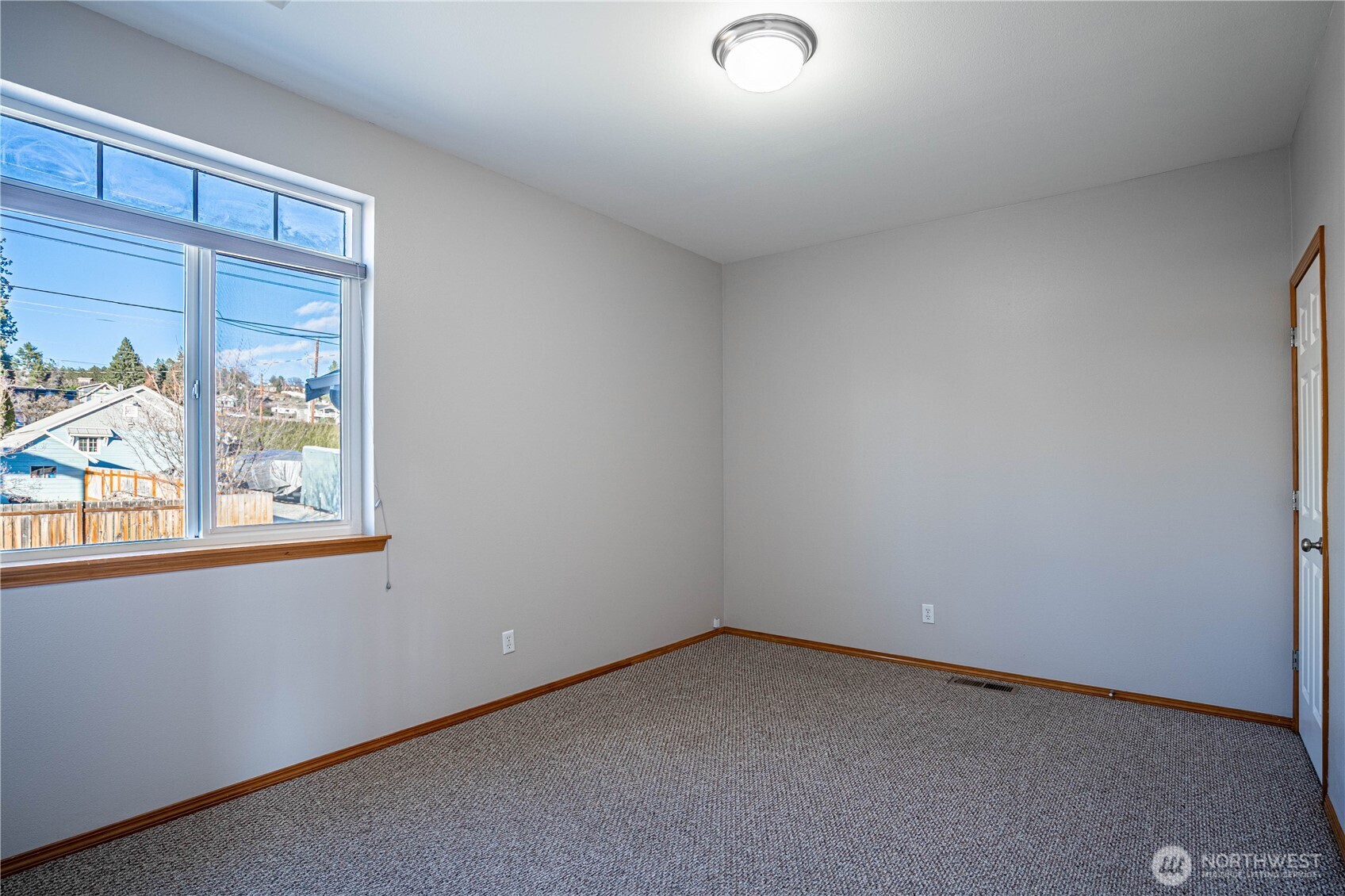 744 Wapato Way, Unit A Manson, WA 98831 - Photo 13 of 32 an empty room with windows