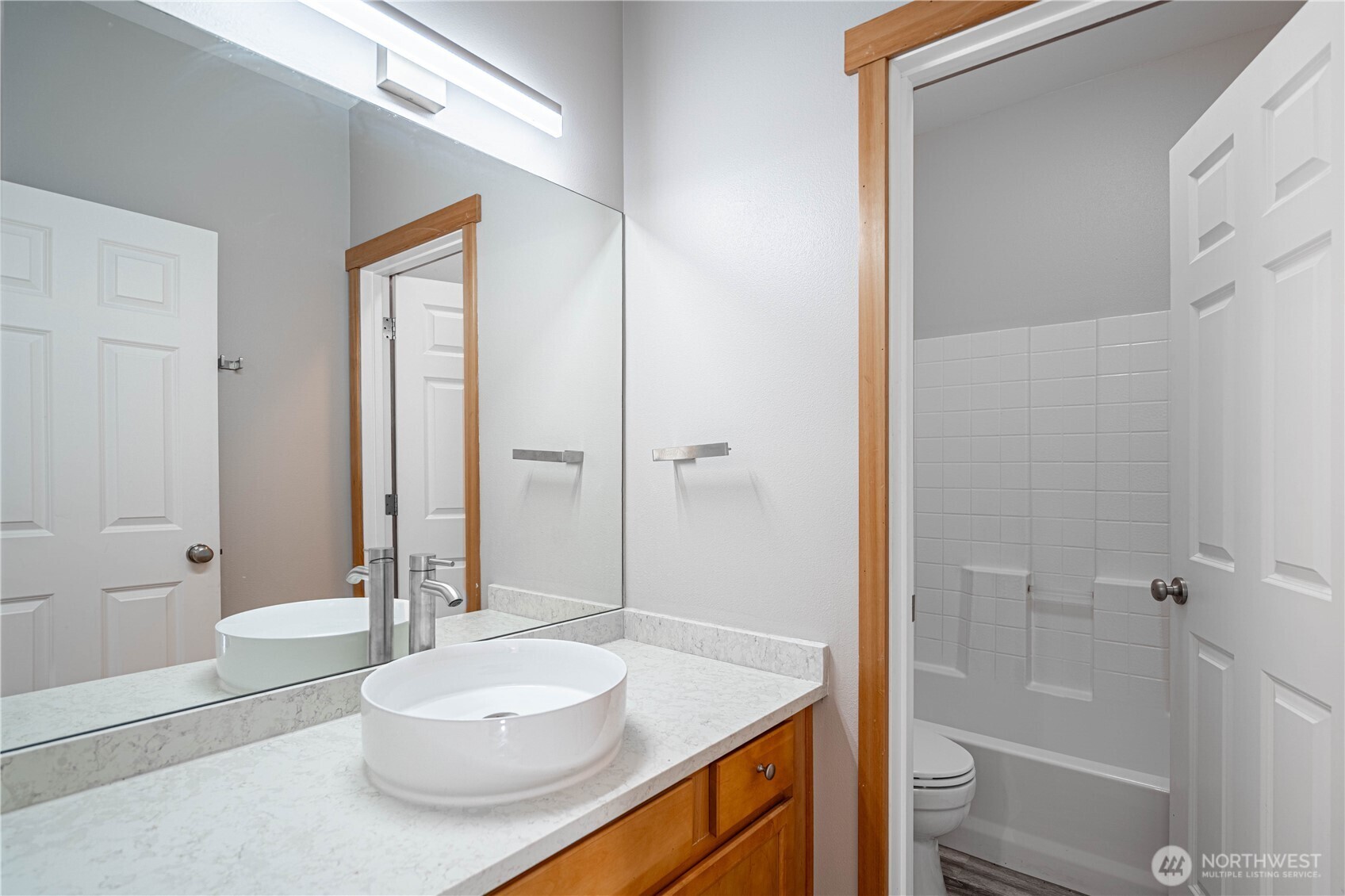744 Wapato Way, Unit A Manson, WA 98831 - Photo 14 of 32 a bathroom with a granite countertop sink and a mirror
