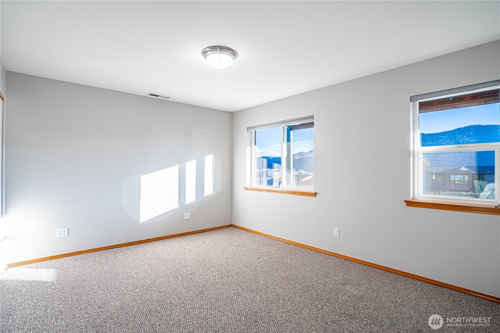 744 Wapato Way, Unit A Manson, WA 98831 - Photo 23 of 32 an empty room with windows