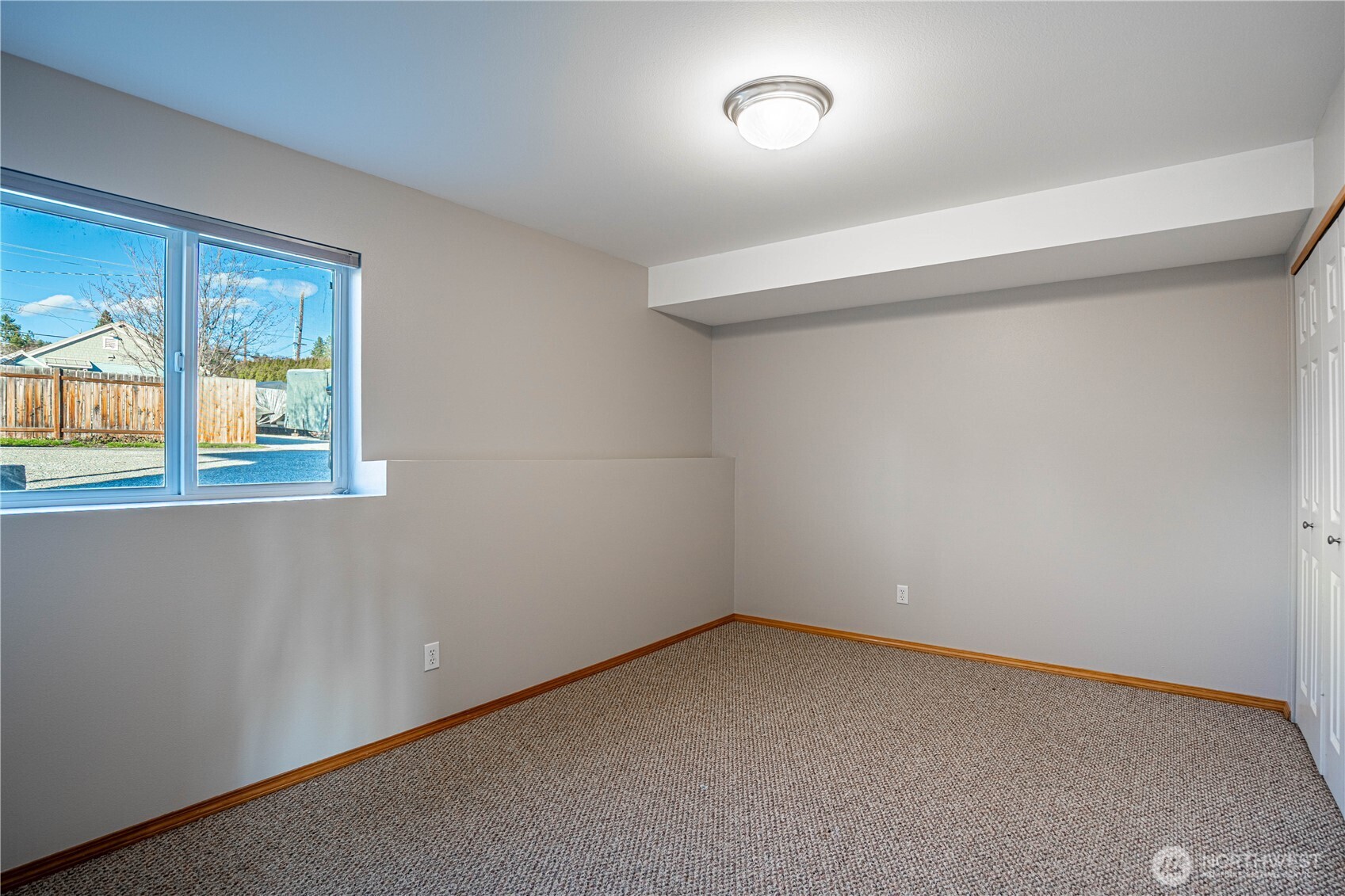 744 Wapato Way, Unit A Manson, WA 98831 - Photo 25 of 32 an empty room with windows
