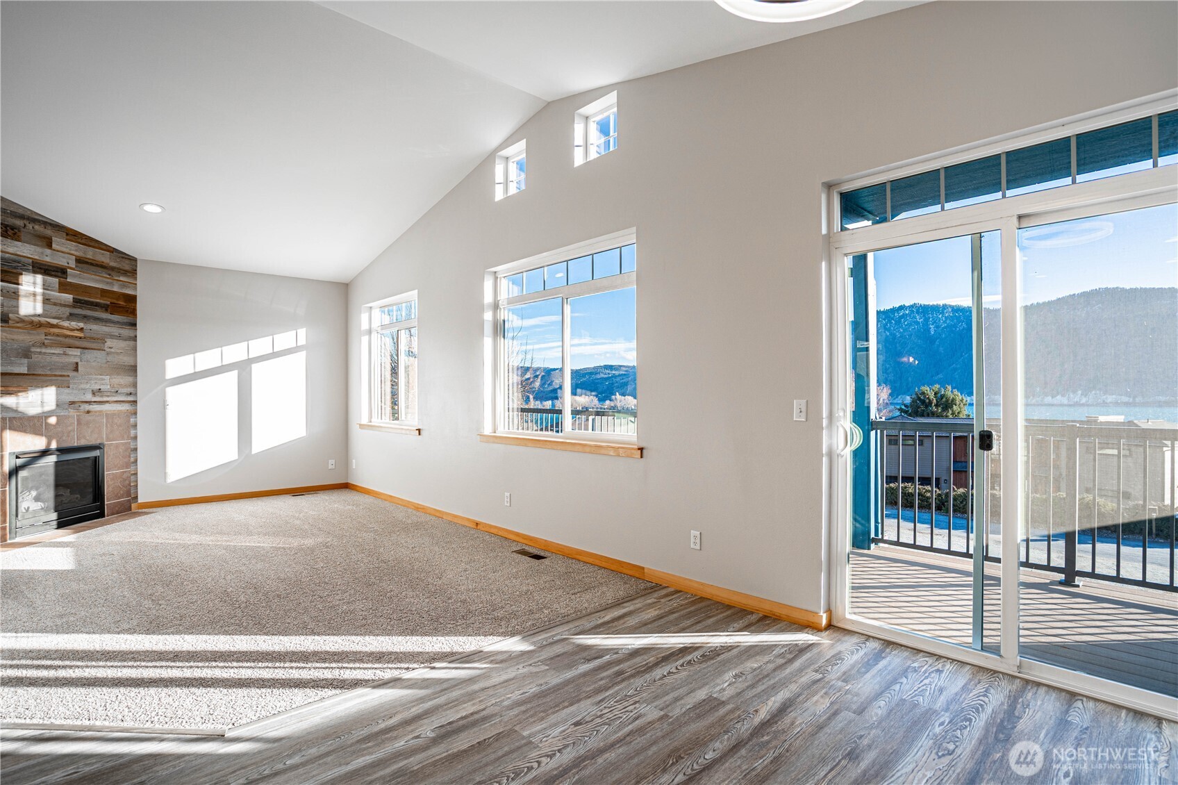 744 Wapato Way, Unit A Manson, WA 98831 - Photo 5 of 32 a view of an empty room with glass door and windows