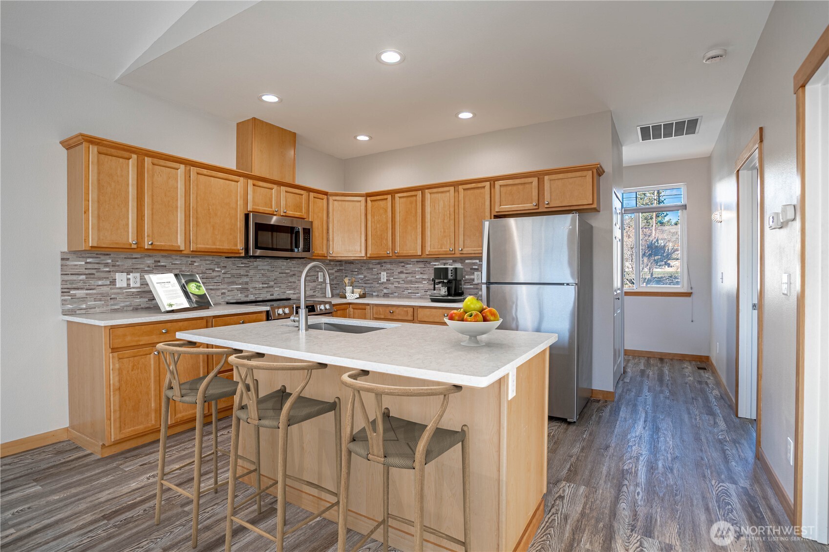 744 Wapato Way, Unit A Manson, WA 98831 - Photo 7 of 32 a kitchen with stainless steel appliances a refrigerator stove microwave and cabinets