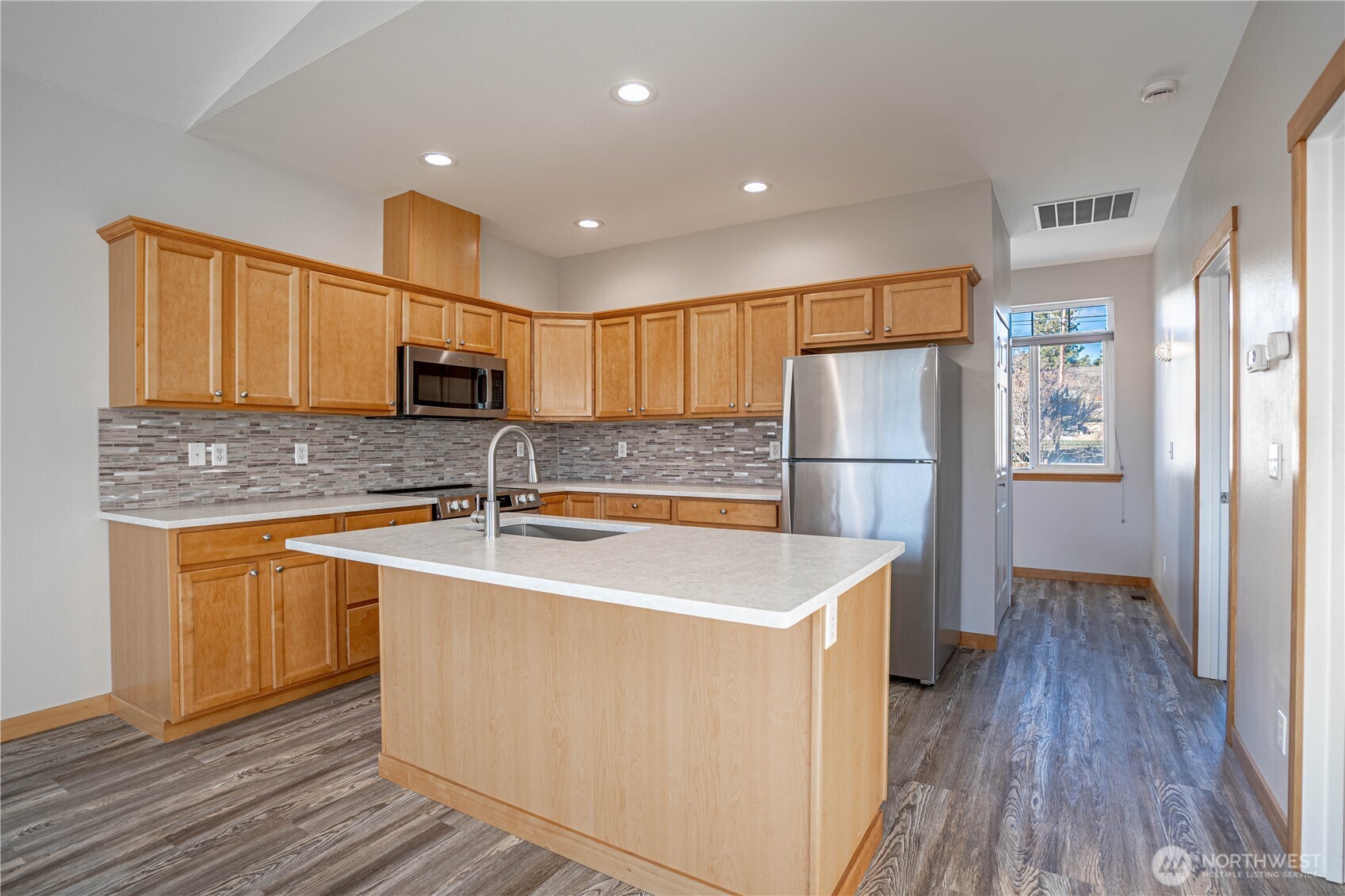 744 Wapato Way, Unit A Manson, WA 98831 - Photo 8 of 32 a kitchen with stainless steel appliances granite countertop a refrigerator and a sink