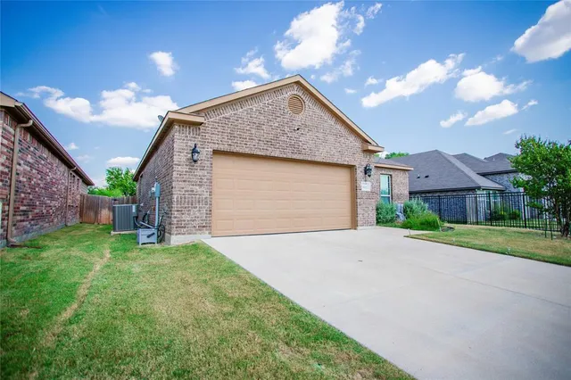 a view of a house with a yard and pathway