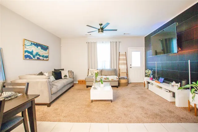 a view of a yard in front of a house with a large tree