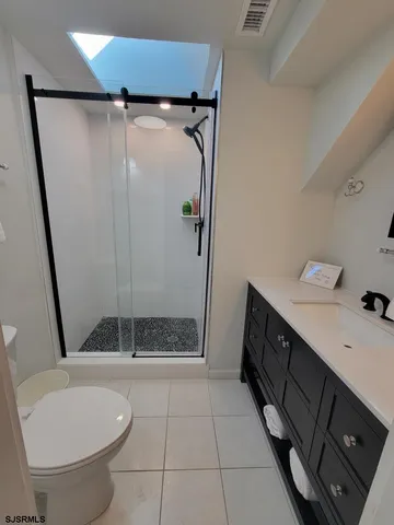 a bathroom with a shower a toilet and sink