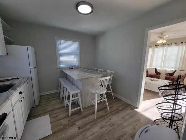a view of a workspace with furniture and a wooden floor