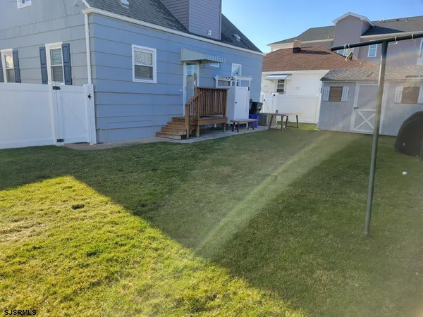 a view of a backyard with brick wall and a chair