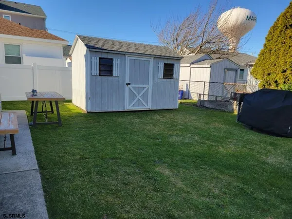 a backyard of a house with table and chairs