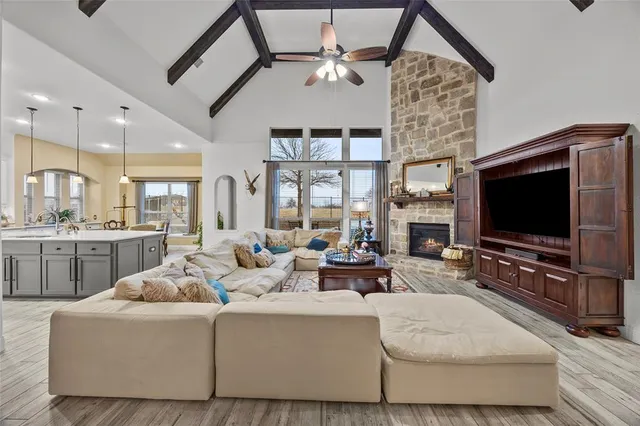 a living room with patio furniture and a fireplace