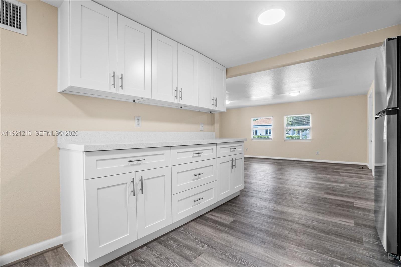 212 Southwest 11th Street Dania Beach, FL 33004 - Photo 13 of 39 a kitchen with stainless steel appliances granite countertop a refrigerator sink and cabinets