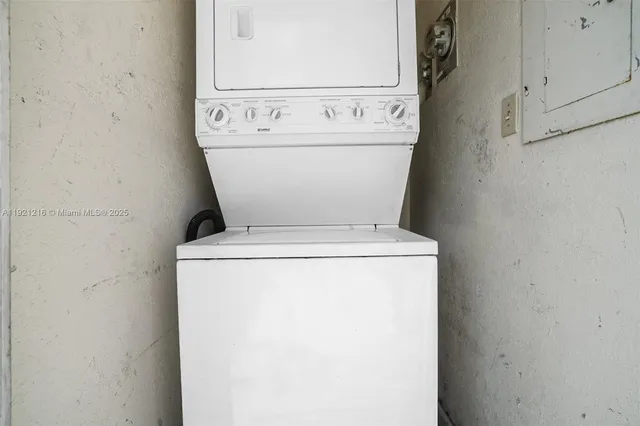 a view of hallway with window and wooden floor