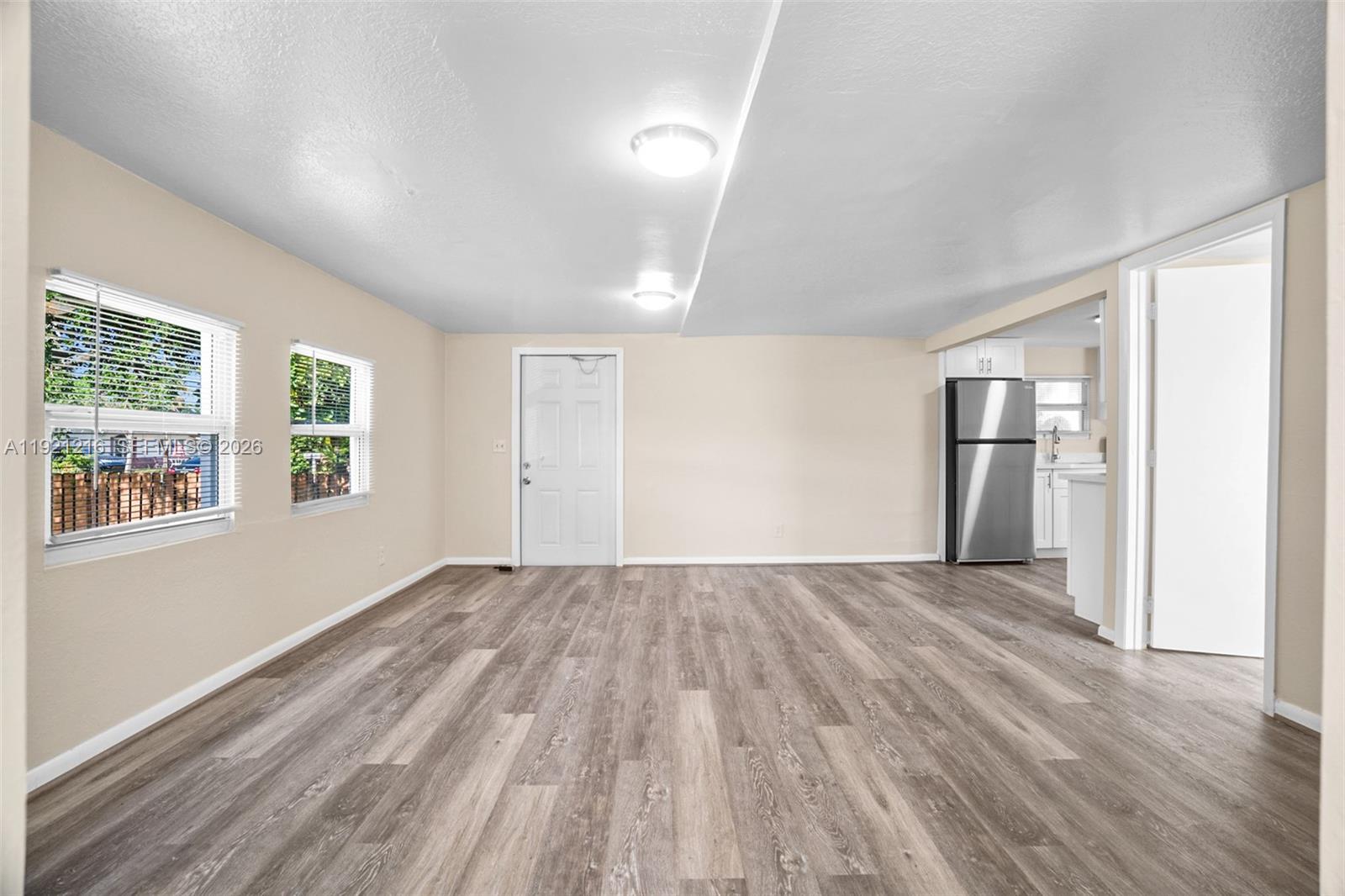 212 Southwest 11th Street Dania Beach, FL 33004 - Photo 4 of 39 wooden floor in an empty room with a window
