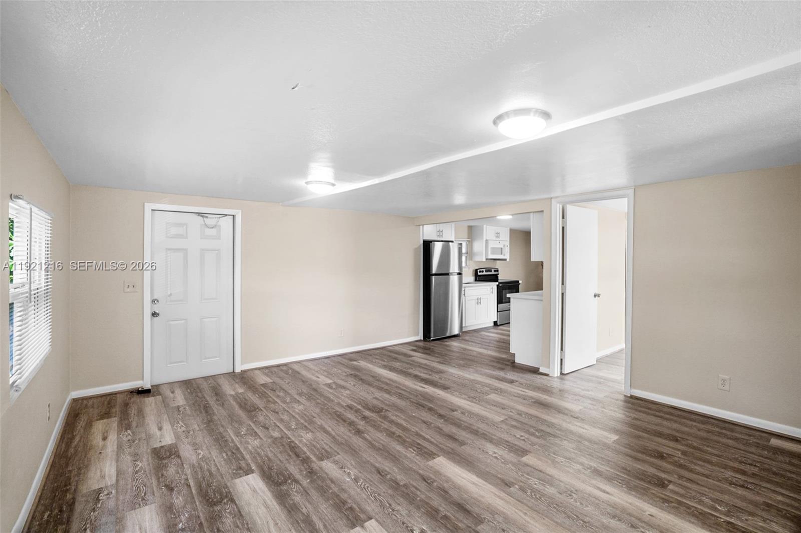 212 Southwest 11th Street Dania Beach, FL 33004 - Photo 10 of 39 a big room with wooden floor and windows