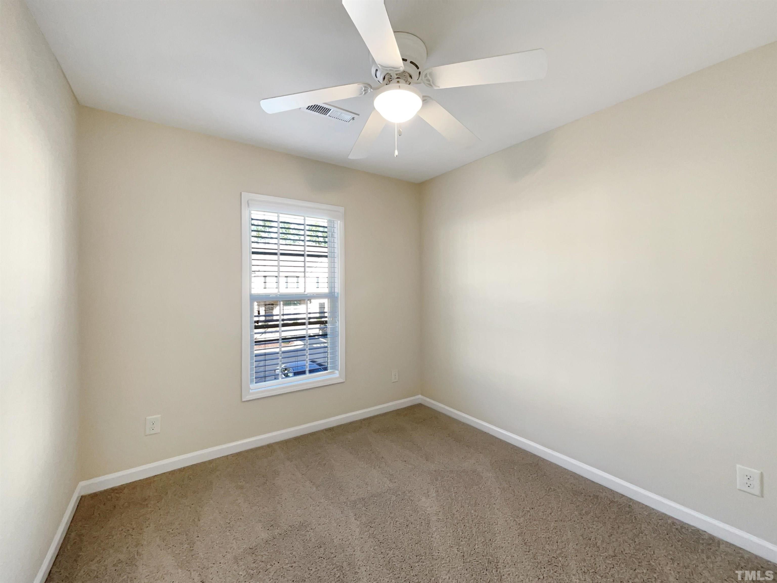 3240 Warm Springs Lane Raleigh, NC 27610 - Photo 17 of 18 an empty room with windows and ceiling fan