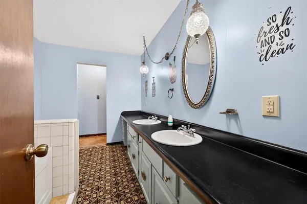 a bathroom with a sink a toilet and a mirror