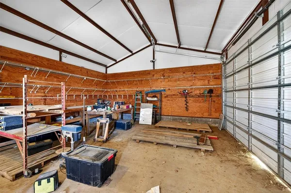 an aerial view of a house with garden space and lake view in back