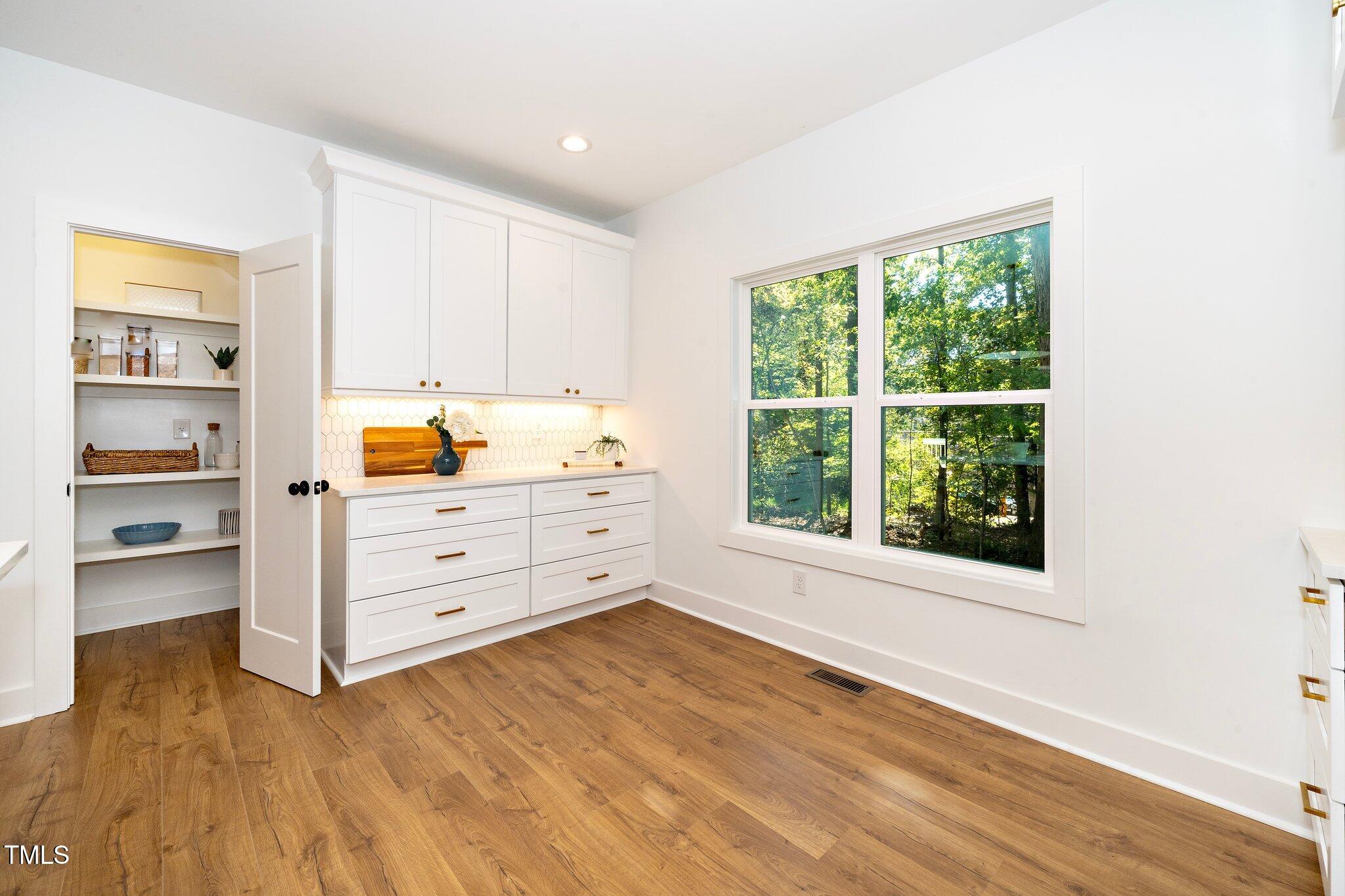8112 Rhudy Place Raleigh, NC 27612 - Photo 18 of 39 a view of a bedroom with wooden floor and cabinet